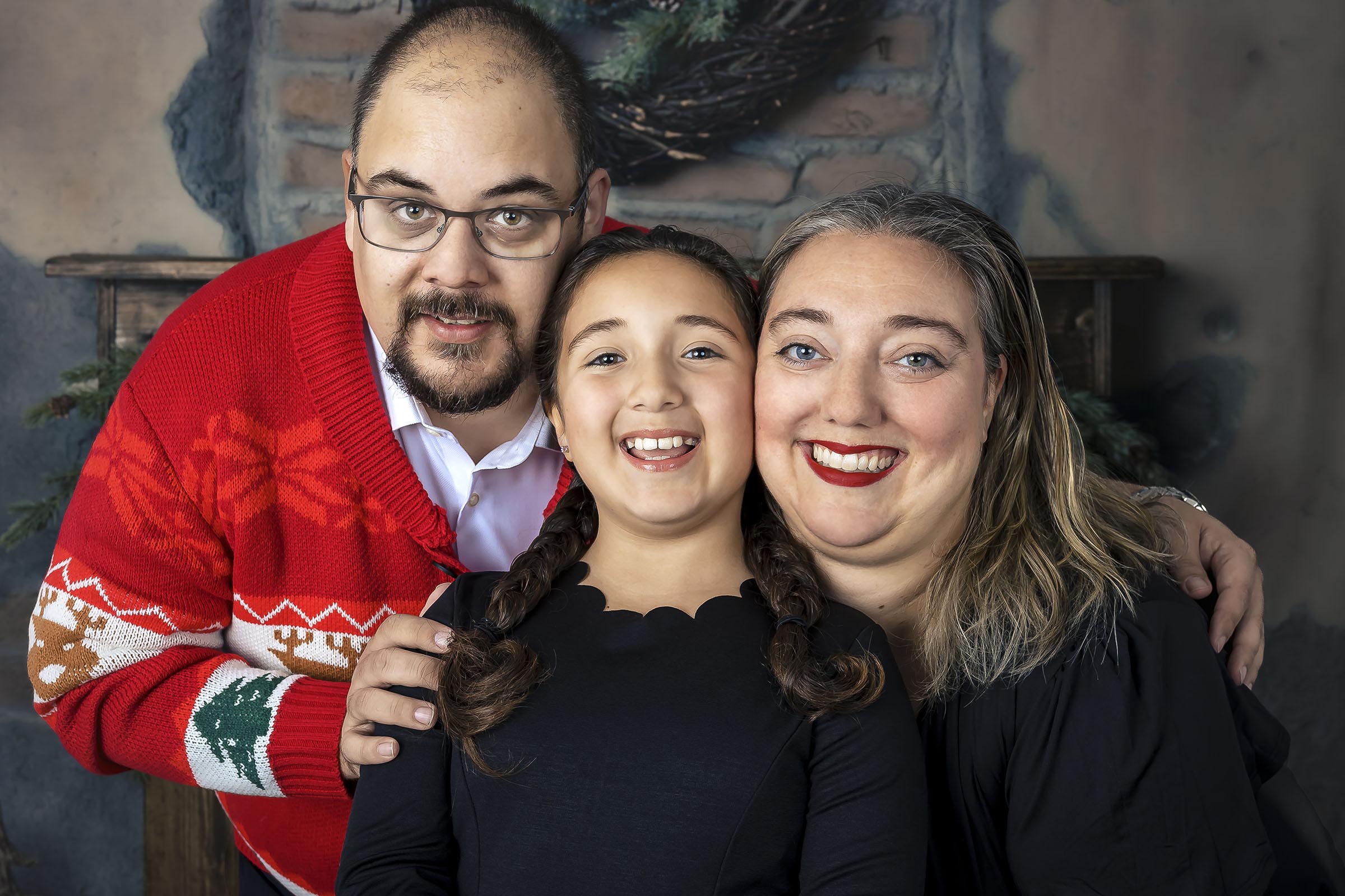 Beaux-arts portrait vertical famille avec jeune fille qui sourit en studio fond rustique par Tobi Malette photographe Vaudreuil-Soulanges et ouest de l'ile de montreal