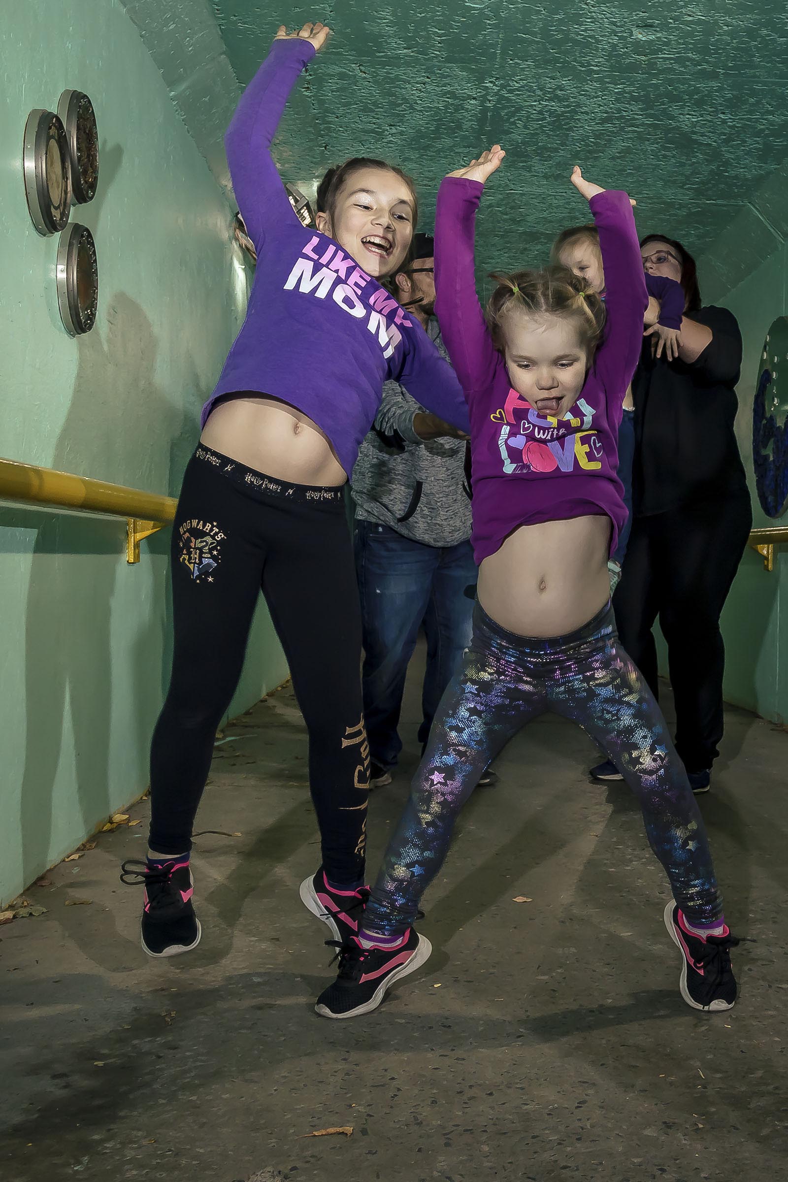Portrait famille deux filles sautent dans un tunnel milieu urbain par Tobi Malette photographe Vaudreuil-Soulanges et ouest de l'ile de montreal